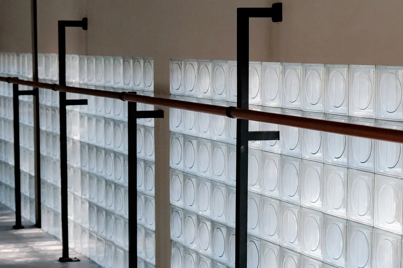 The ballet barre along the glass-block wall in the ASAI GYM studio