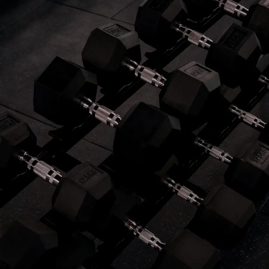 A rack of dumbbells on the ASAI GYM floor