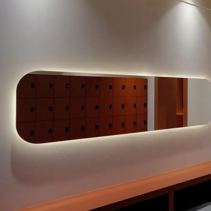 Backlit mirror above the lockers at ASAI GYM