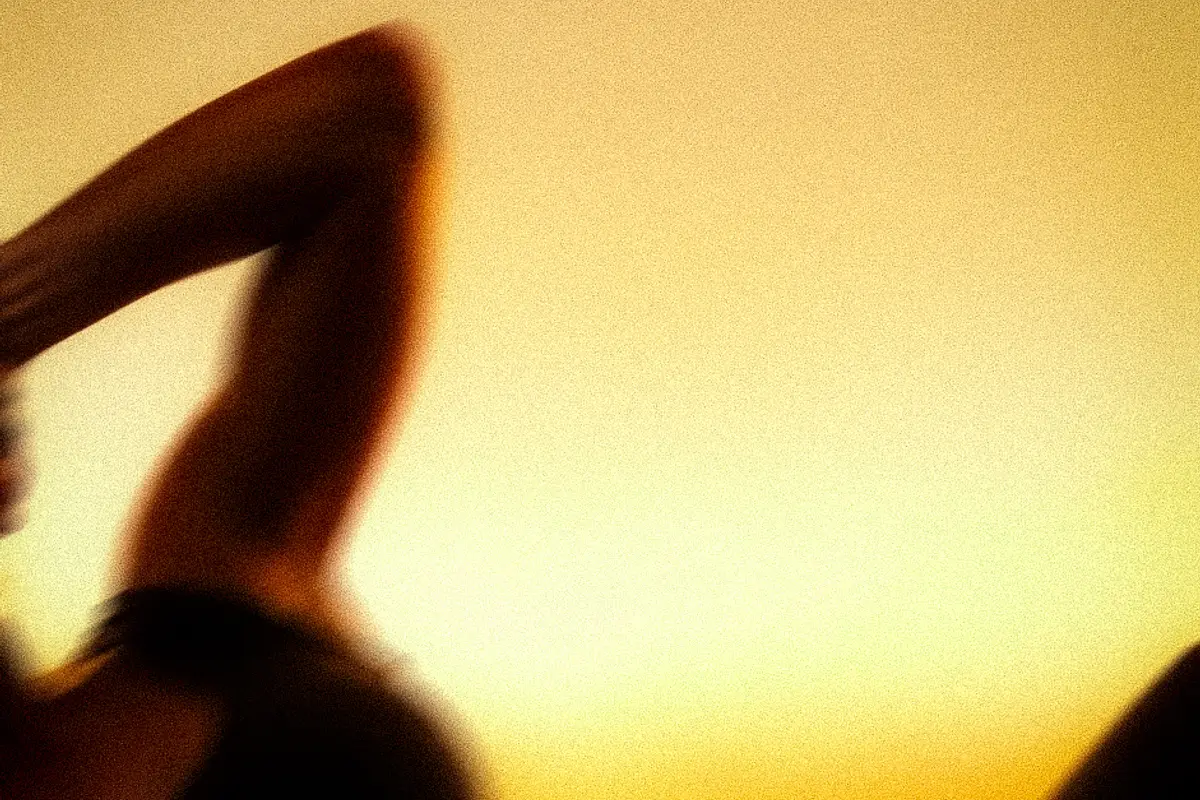 A member training in silhouette against the amber light of the ASAI GYM studio