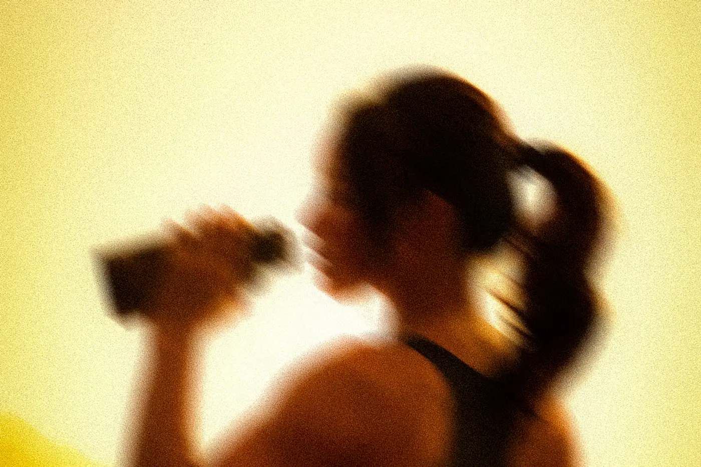 A member drinking from an ASAI GYM bottle after a session