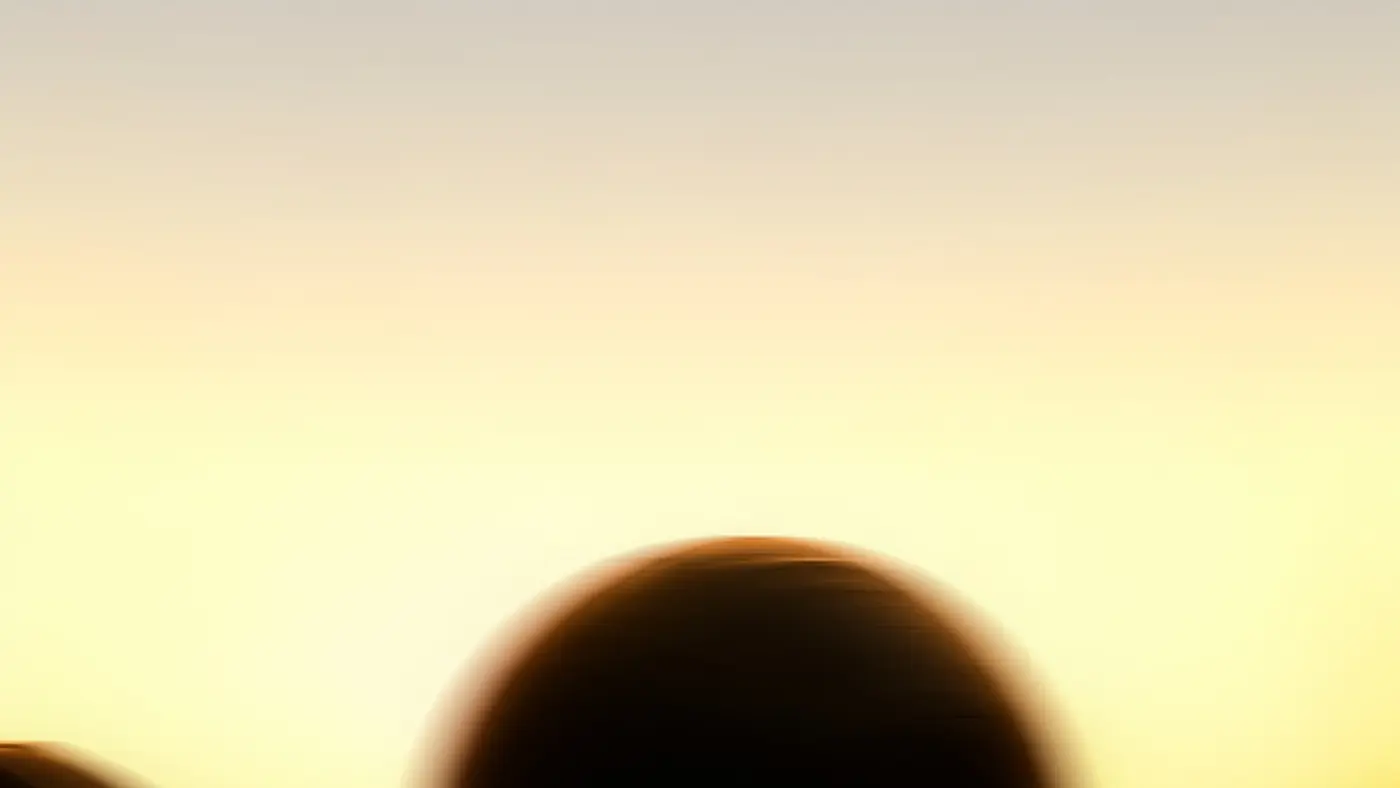A medicine ball lifted against the dawn sky at ASAI GYM