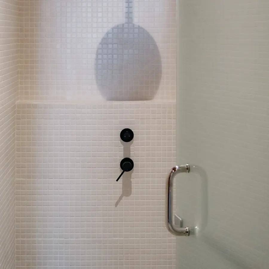 A shower in the tiled washroom at ASAI GYM